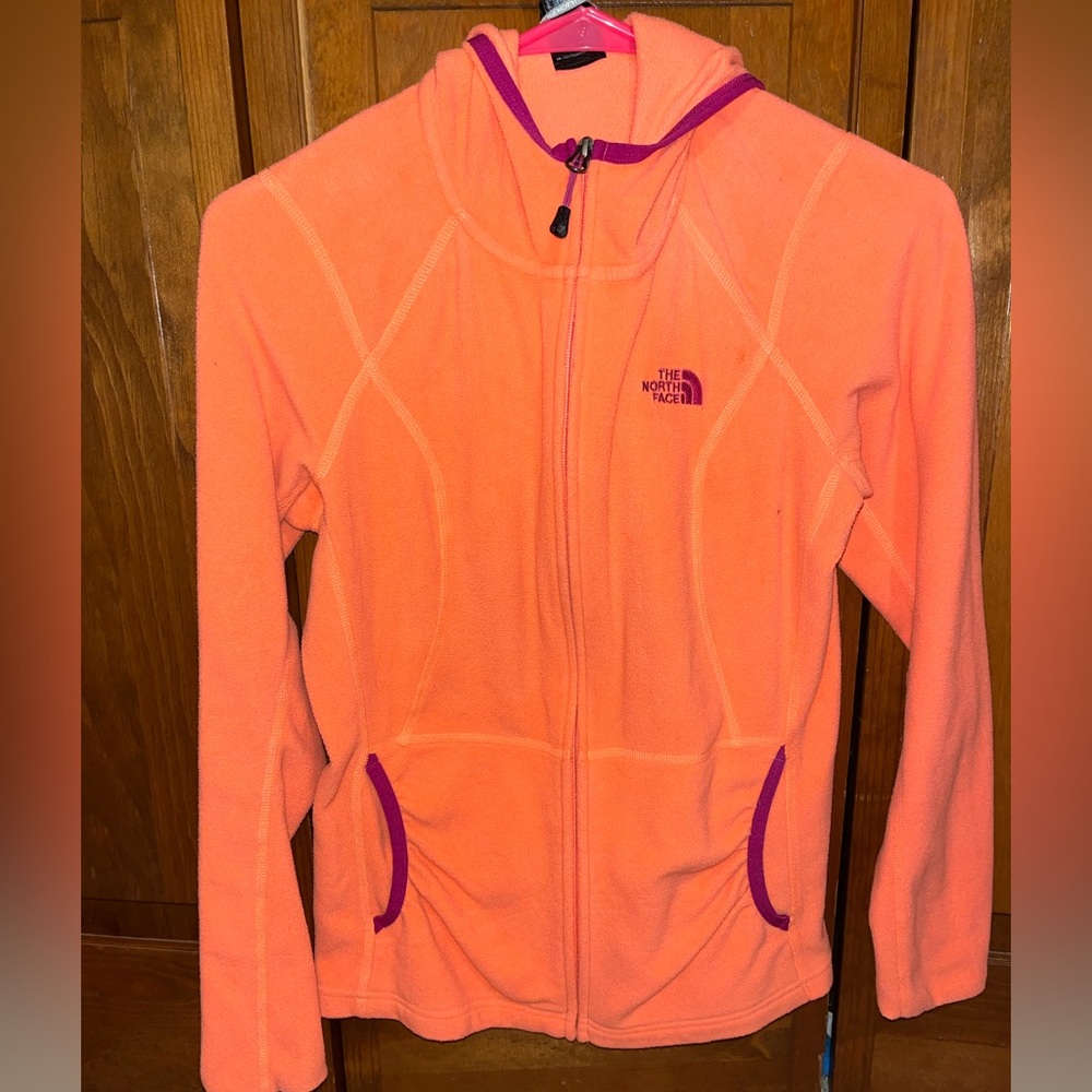 North face, coral/orange fleece jacket.